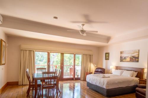 a bedroom with a bed and a table and chairs at Birdwood Motel in Birdwood