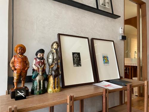 a table with three pictures and statues on it at GalileOasis Boutique Hotel in Bangkok