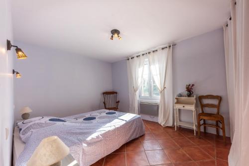 a bedroom with a bed and a desk and a window at L'horizon Vert - Avec piscine et parking privé in Artignosc-sur-Verdon