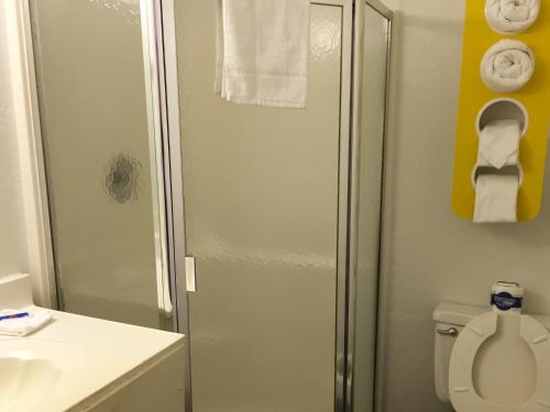 a bathroom with a shower and a toilet and a sink at Motel 6 - Pensacola West in Pensacola