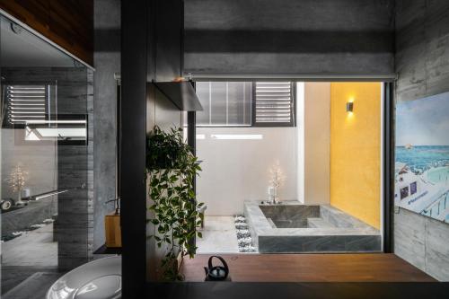 a bathroom with a tub and a large window at Color Coral Boutique Hotel in Magong