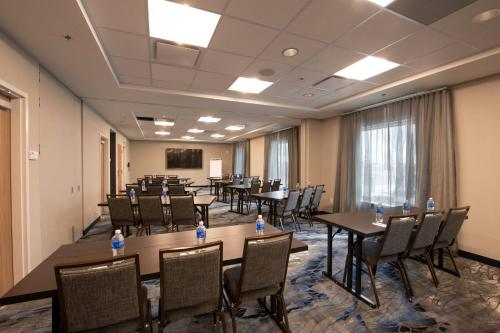 a conference room with tables and chairs and a podium at Fairfield by Marriott Edmonton International Airport in Edmonton