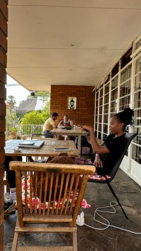 a child sitting in a chair at a table at ParadiseGarden Backpackers in Windhoek