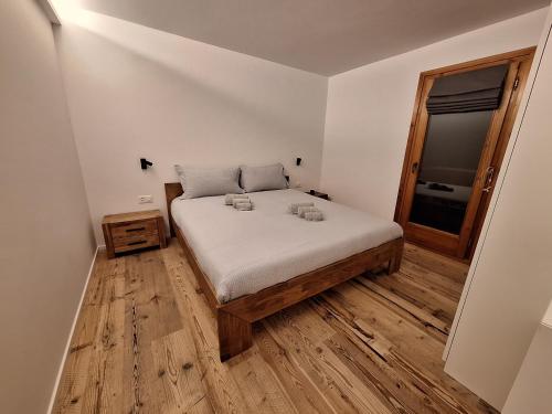 a bedroom with a bed and a wooden floor at Lake 27 - St Moritz in St. Moritz