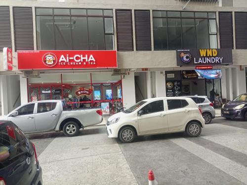 a group of cars parked in front of a store at Nilai 青年城 Youth City C 25 15 in Nilai