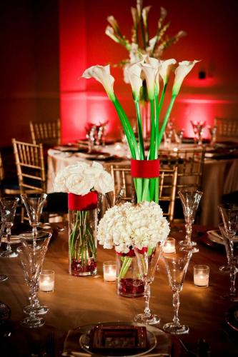 a table with vases of flowers and candles at Boston Marriott Peabody in Peabody