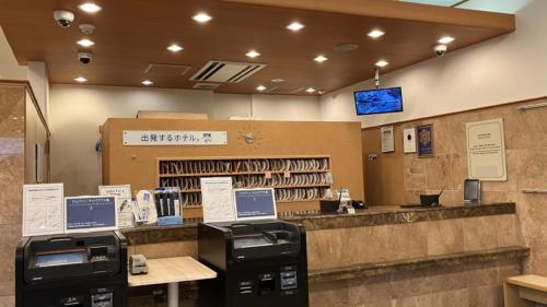 a restaurant with a cashier and a counter with printers at Toyoko Inn Yonezawa Ekimae in Yonezawa