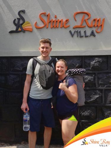 two people standing in front of a shine ray villa at Shine Ray VILLA in Galle