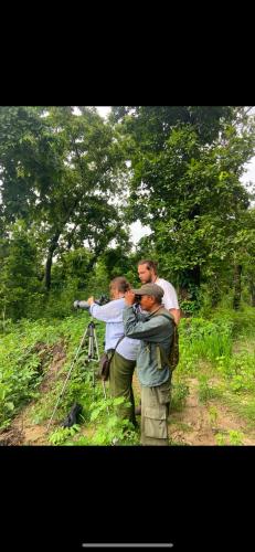 a group of people standing in front of a camera at Happy Lemon Tree lodge in Sauraha