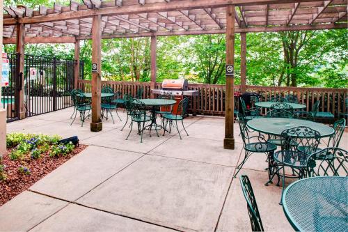a patio with tables and chairs under a pergola at TownePlace Suites Atlanta Buckhead in Atlanta