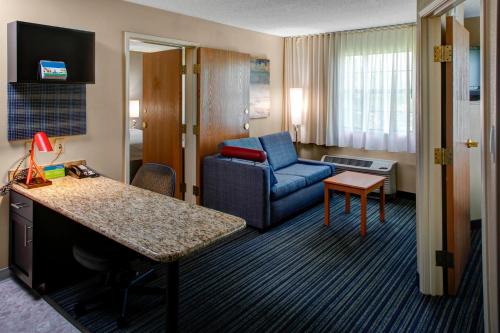 a hotel room with a couch and a chair at TownePlace Suites Atlanta Buckhead in Atlanta