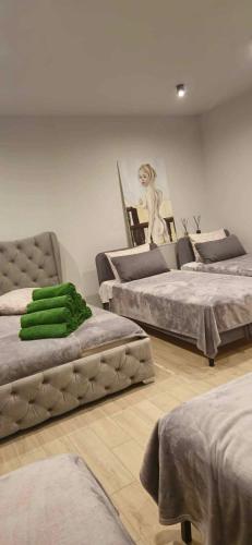 a room with three beds and a chair in it at Sodyba Azagis in Vilkanastrai