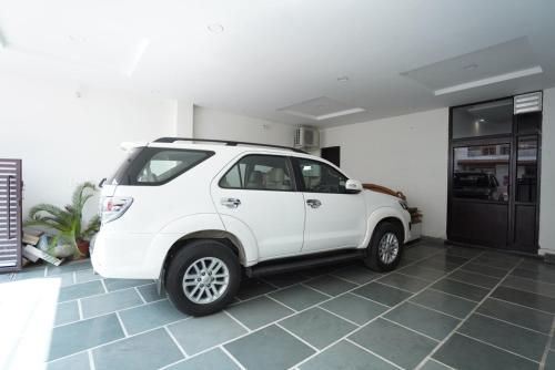 a white car is parked in a garage at Hotel Star Inn Opp Kalpna Chawla Civil Hospital Karnal, Kunjpura Road in Karnal