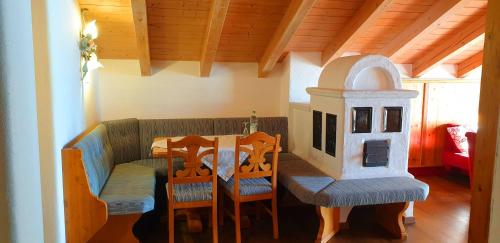 a dining room with a table and a toy house at Alpenotel Rosenhof Ruhpolding, Wellness, Chiemgau Karte, Travelingo Bonus Programm in Ruhpolding