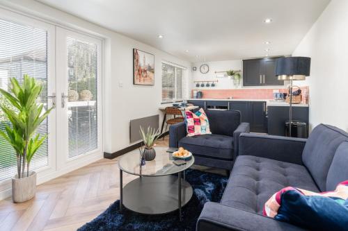 a living room with two couches and a table at The Lodge in Woodplumpton