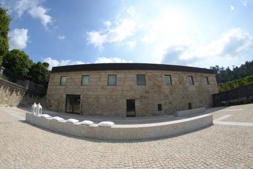 a large stone building with a circular roof at Quinta das Lavandeiras - Caldas de Vizela in Vizela