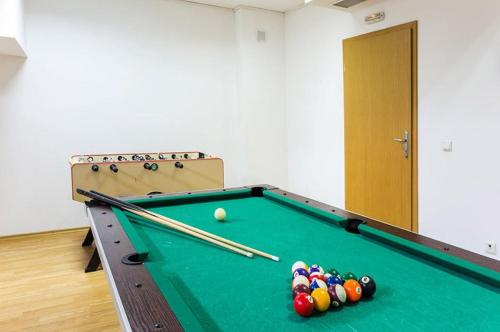 a pool table with balls and bats on it at Alpine Relax free spa & pool in Pamporovo