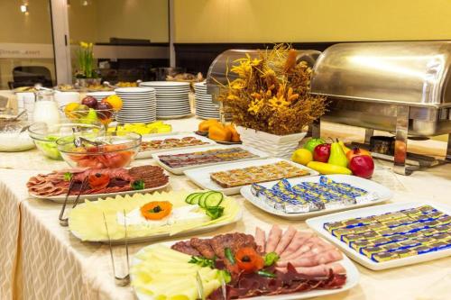 a buffet with many different types of food on a table at Alpine Relax free spa & pool in Pamporovo