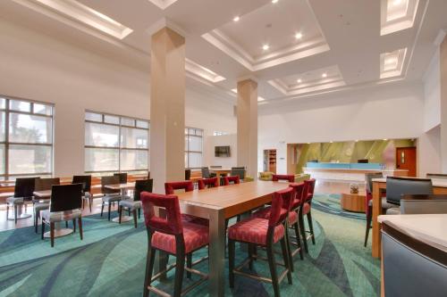 a conference room with a wooden table and chairs at SpringHill Suites by Marriott Orlando Lake Buena Vista South in Kissimmee