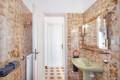 a bathroom with a sink and a mirror at Villa In Collina Vista Mare in Sanremo