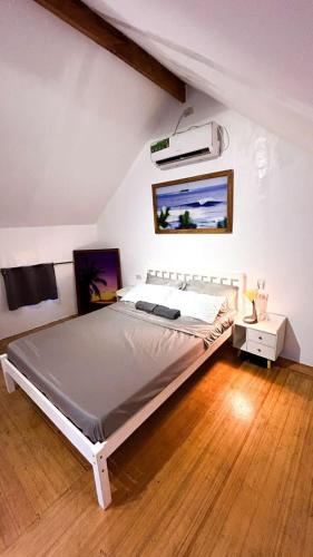 a bedroom with a large bed in a attic at La Casita Catangnan in General Luna