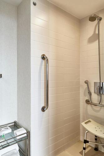 a bathroom with a shower with a toilet and a sink at Residence Inn by Marriott Rio de Janeiro Barra da Tijuca in Rio de Janeiro