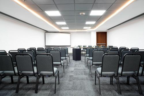 a conference room with chairs and a white screen at Residence Inn by Marriott Rio de Janeiro Barra da Tijuca in Rio de Janeiro