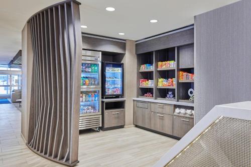 a kitchen with a refrigerator with drinks in it at SpringHill Suites by Marriott Chicago Chinatown in Chicago