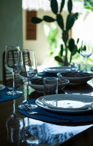 a table with plates and glasses on a table at Villa design avec piscine privée à El Nido in El Nido
