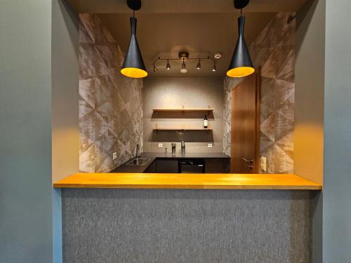 a kitchen with two lights above a counter at Long Valley Lodge in Þingeyrar