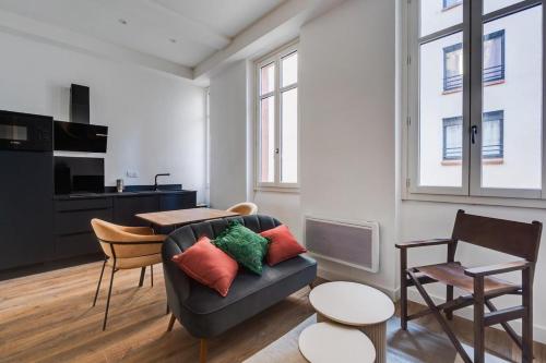 un salon avec un canapé et une table dans l'établissement La suite Impériale - Hypercentre, à Toulouse