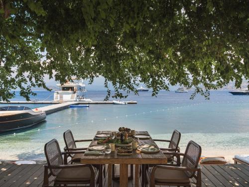 a table and chairs with a view of the water at Yazz Collective in Fethiye