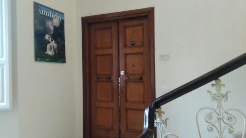 a staircase with a wooden door in a room at The Angela's House and large balcony on the square in Todi