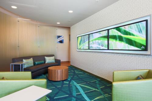 a waiting room with a couch and a window at SpringHill Suites by Marriott San Jose Airport in San Jose