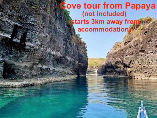 a boat in a river with the words cover tour from papaya not included at 2BR townhouses good for 12pax each & NETFLIX & 100Mbps WIFI & pool resort 2min walk & 3km outside Pico de Loro Cove & Calayo Cove - with Endorsement for Pico de Loro Cove good for 7 days & Boat-Tour & Island Hopping assistance in Nasugbu