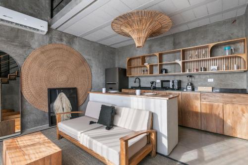 a kitchen with a counter and a chair and a fireplace at Grand Loft with Rooftop Pool in the heart Cancun in Cancún