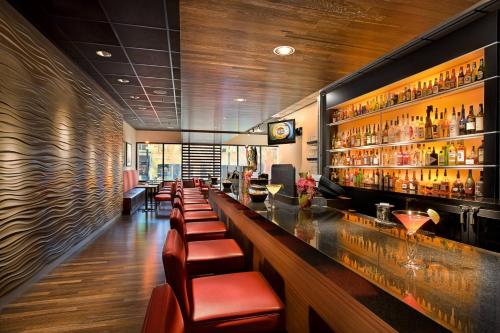 a bar with a long counter with a bunch of bottles at Salt Lake Marriott Downtown at City Creek in Salt Lake City