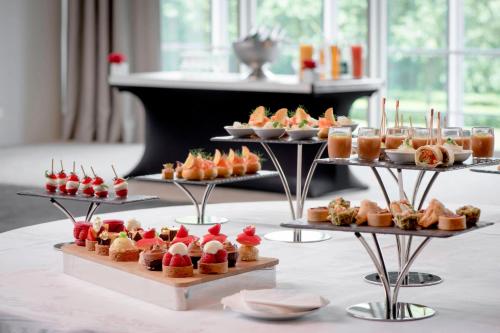 a display of desserts and pastries on a table at Lyon Marriott Hotel Cité Internationale in Lyon