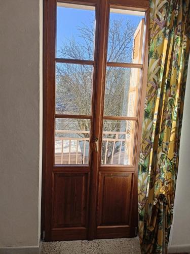a wooden door in a room with a window at La Casa Rossa -Dimora di campagna in Montechiaro D'acqui