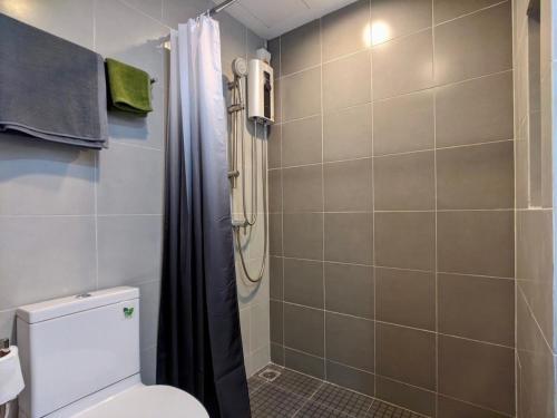 a bathroom with a toilet and a shower at Elio Sukhumvit 64: Chic Space in Bangkok