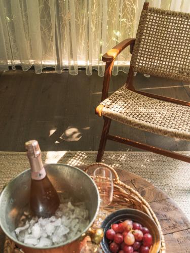 a table with a bottle of champagne and a basket of grapes at Yazz Collective in Fethiye