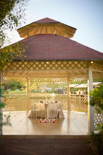 a gazebo with a table and chairs under it at The Westin Reserva Conchal, an All-Inclusive Golf Resort & Spa in Playa Conchal