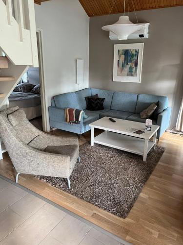 a living room with a blue couch and a coffee table at Katinkulta Apartments in Vuokatti
