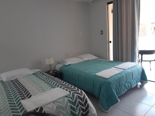 Ένα ή περισσότερα κρεβάτια σε δωμάτιο στο El Valle Lunahuaná