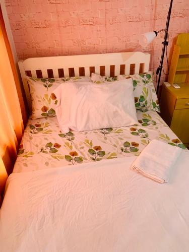 a bed with a white comforter and pillows at A's Place - Large, 2 Bedroom Close to the Airport! in Sibulan
