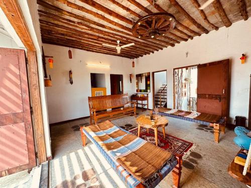 a living room with a couch and a table at 2-BHK 'Nature's Haven Farmhouse' Pune-baramati Highway in Sāngwi