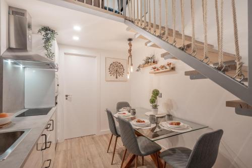 a kitchen and dining room with a table and chairs at Suite Guillem Jáfer by Host Valencia in Valencia
