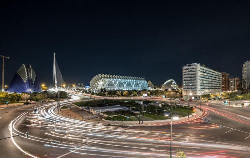 a busy city street at night with cars at Suite Guillem Jáfer by Host Valencia in Valencia