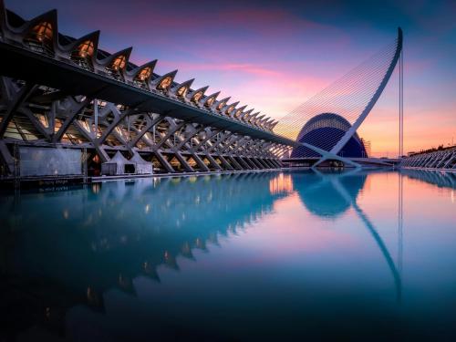 a bridge over a body of water with a building at Suite Guillem Jáfer by Host Valencia in Valencia