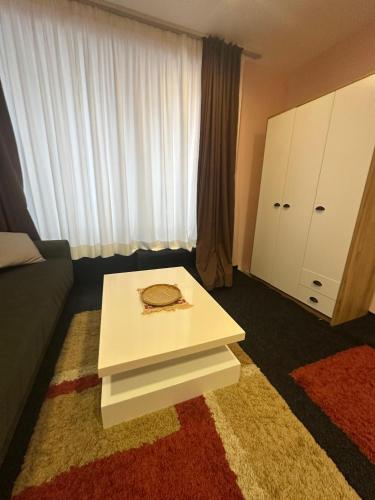 a room with a white table and a large window at Comfort Studio Prishtina City Centre in Pristina